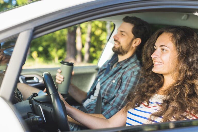 Young couple driving with their Bear River auto insurance in Utah